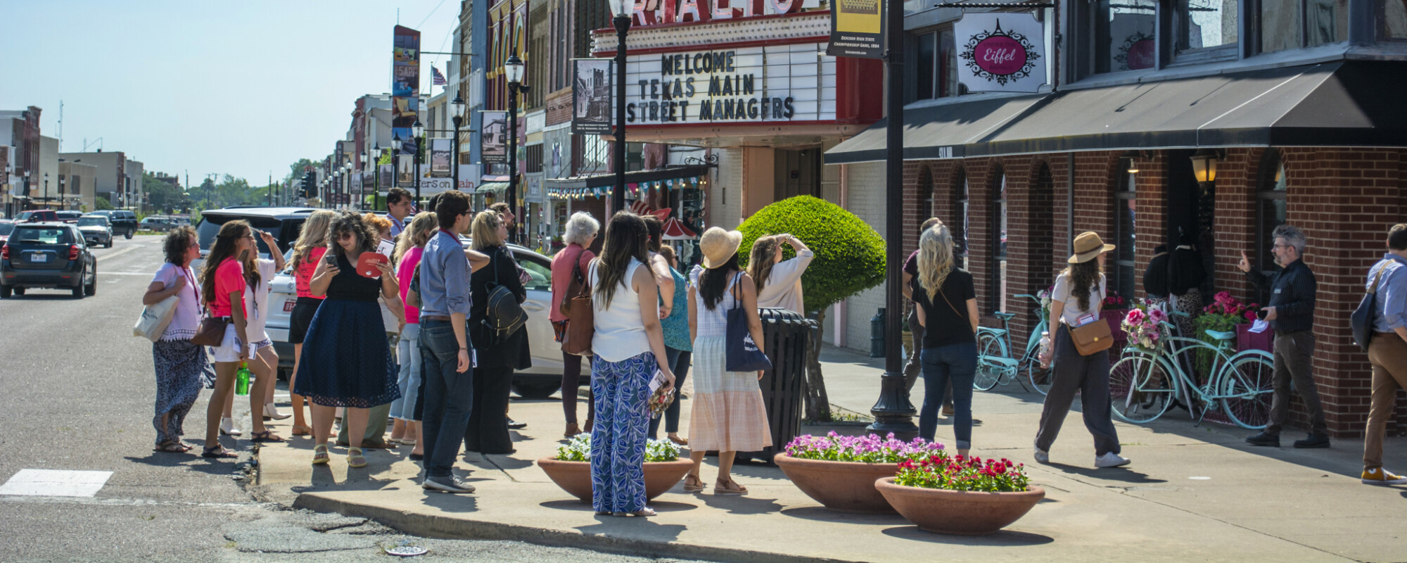 A group of people look at buildings.