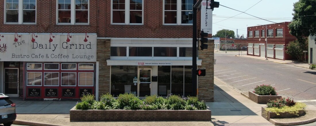 Historic red brick corner building with a coffee shop